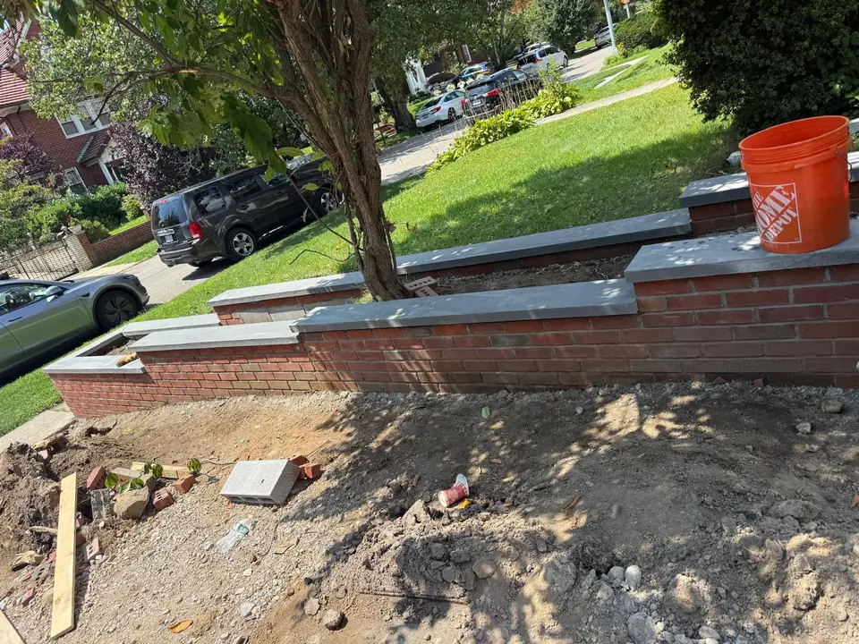 New brick garden wall with stone caps