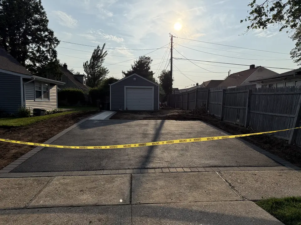 Newly poured concrete driveway taped off while it cures