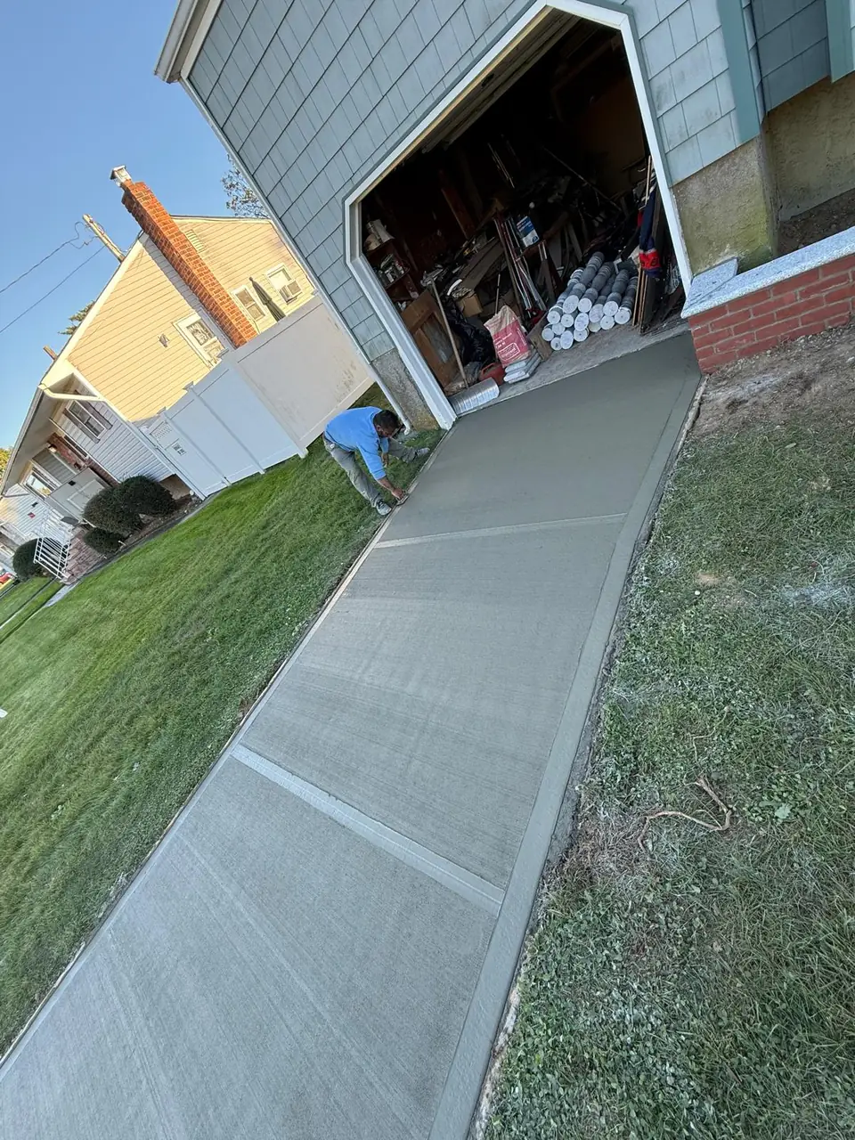 New broom-finished concrete walkway leading to a garage