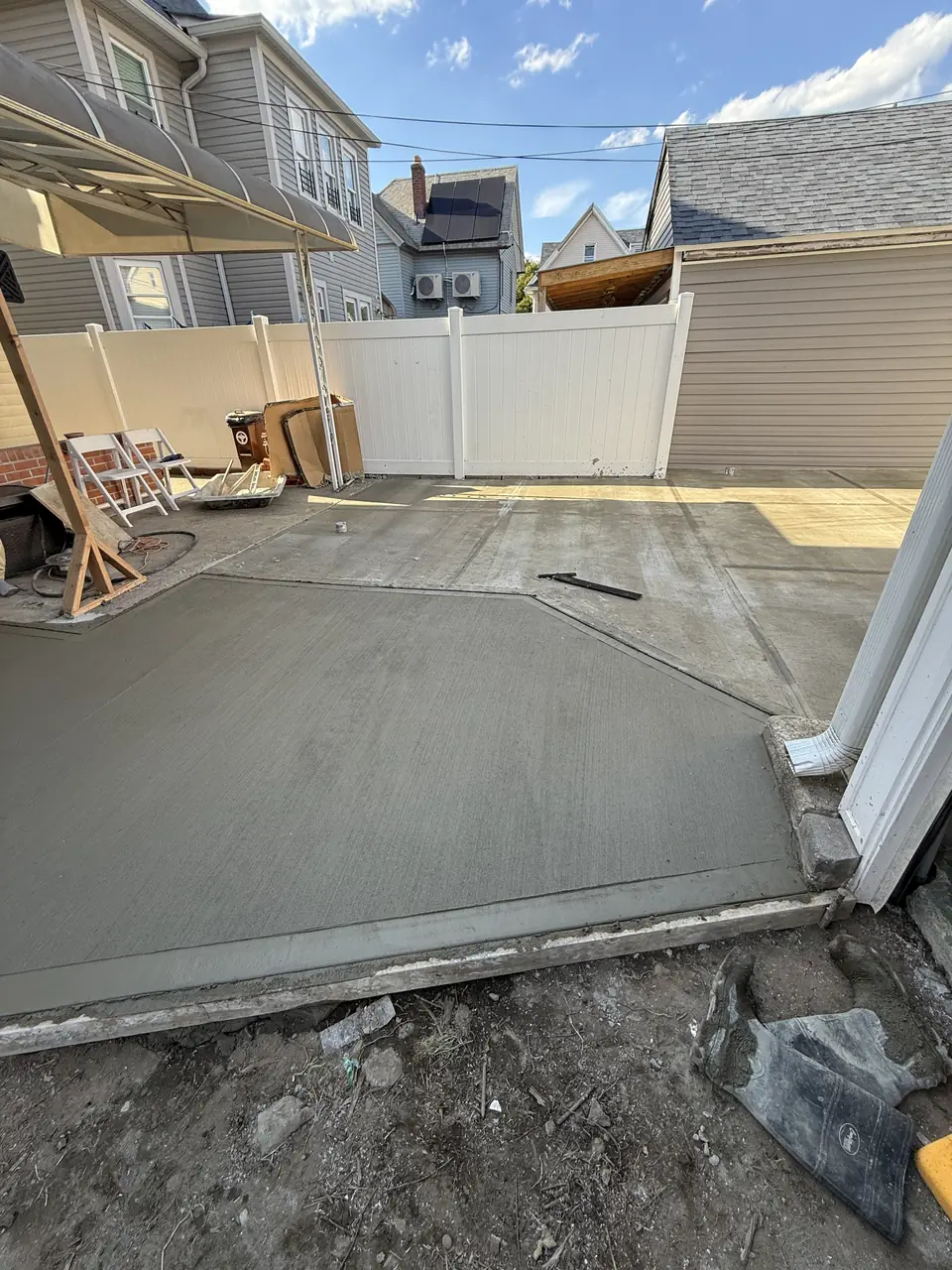 Freshly finished concrete slab in a backyard