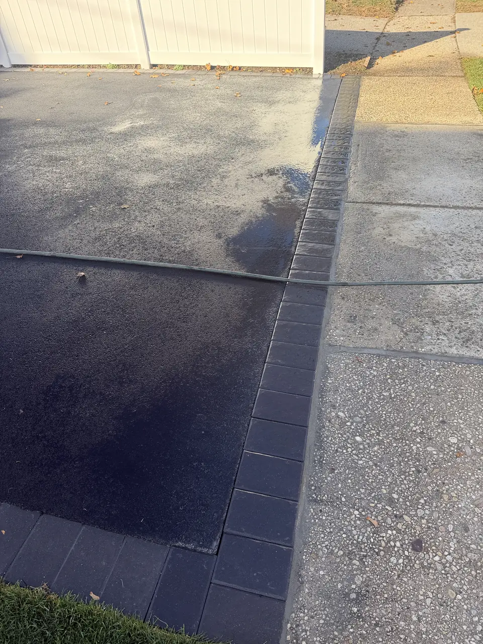 Dark paver border along a driveway