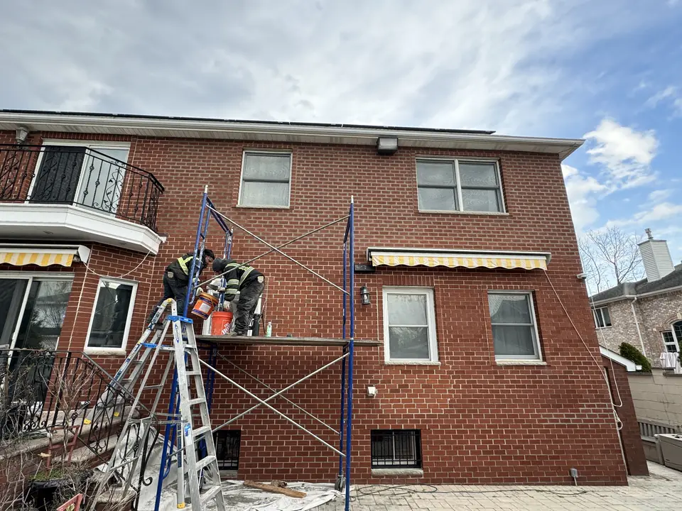 Scaffolding set up for brick work on a two-story brick house